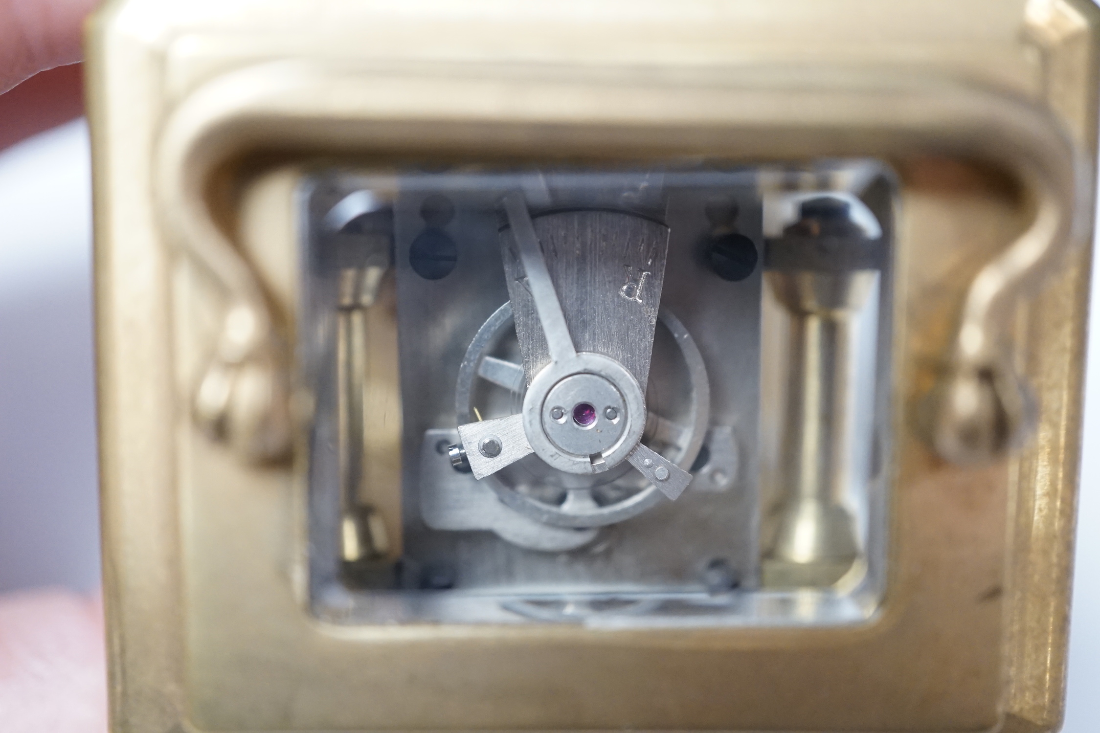 A small brass cased carriage timepiece with key, 9cm high